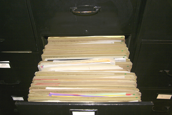 An open file drawer displaying folders full of papers.