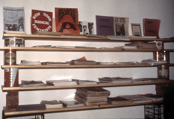 A homemade shelf containing stacks of periodicals.